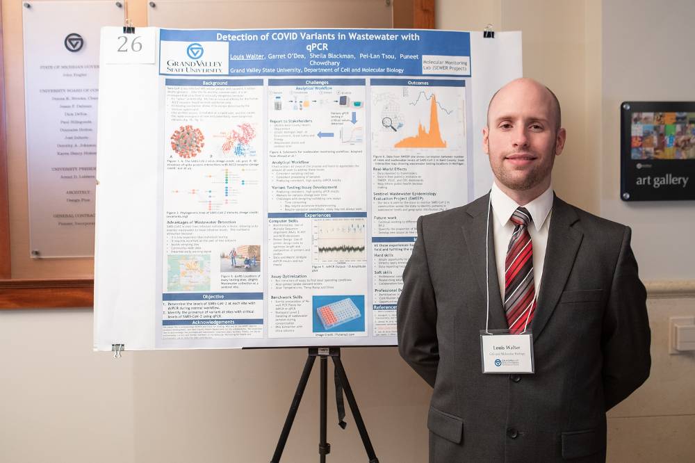 Cell and Molecular Biology graduate student, Louis Walter, standing in front of his poster.